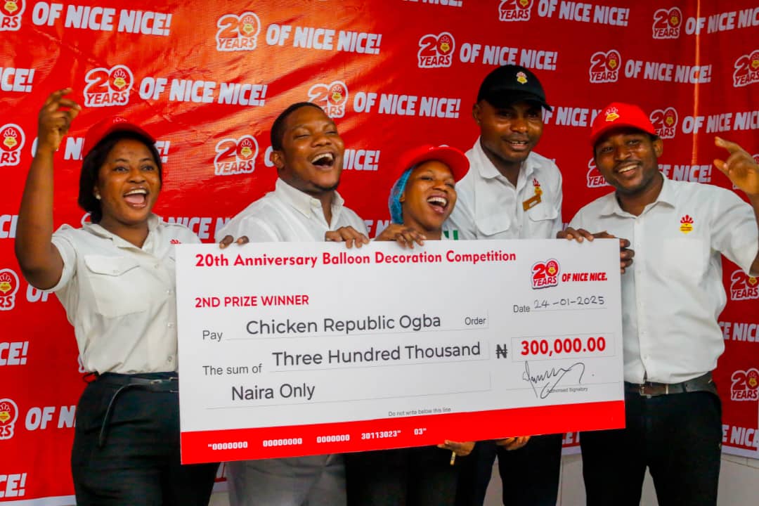 Chicken Republic Ogba team holding their second prize cheque at the 20th anniversary balloon decoration competition